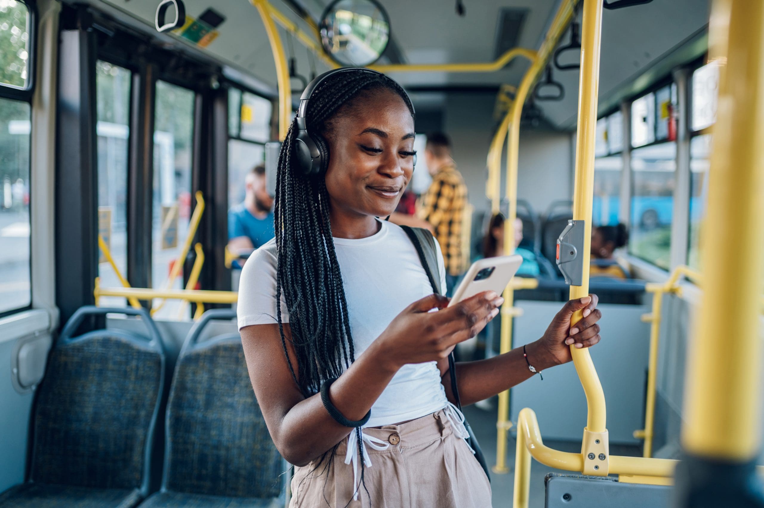 African american woman using smartphone while riding a King County Metro bus